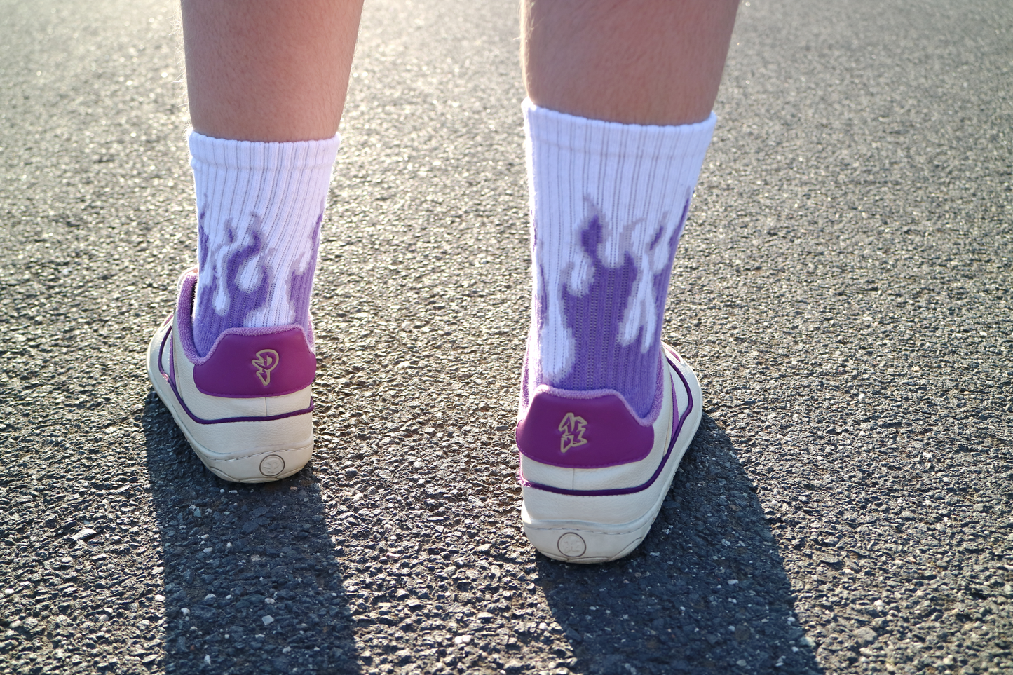 Back view of PLUM sneakers on feet on the street