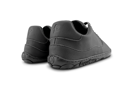 BACK VIEW OF ALL BLACK BAREFOOT SNEAKER, WITH P AND K ON THE BACK OF THE HEEL