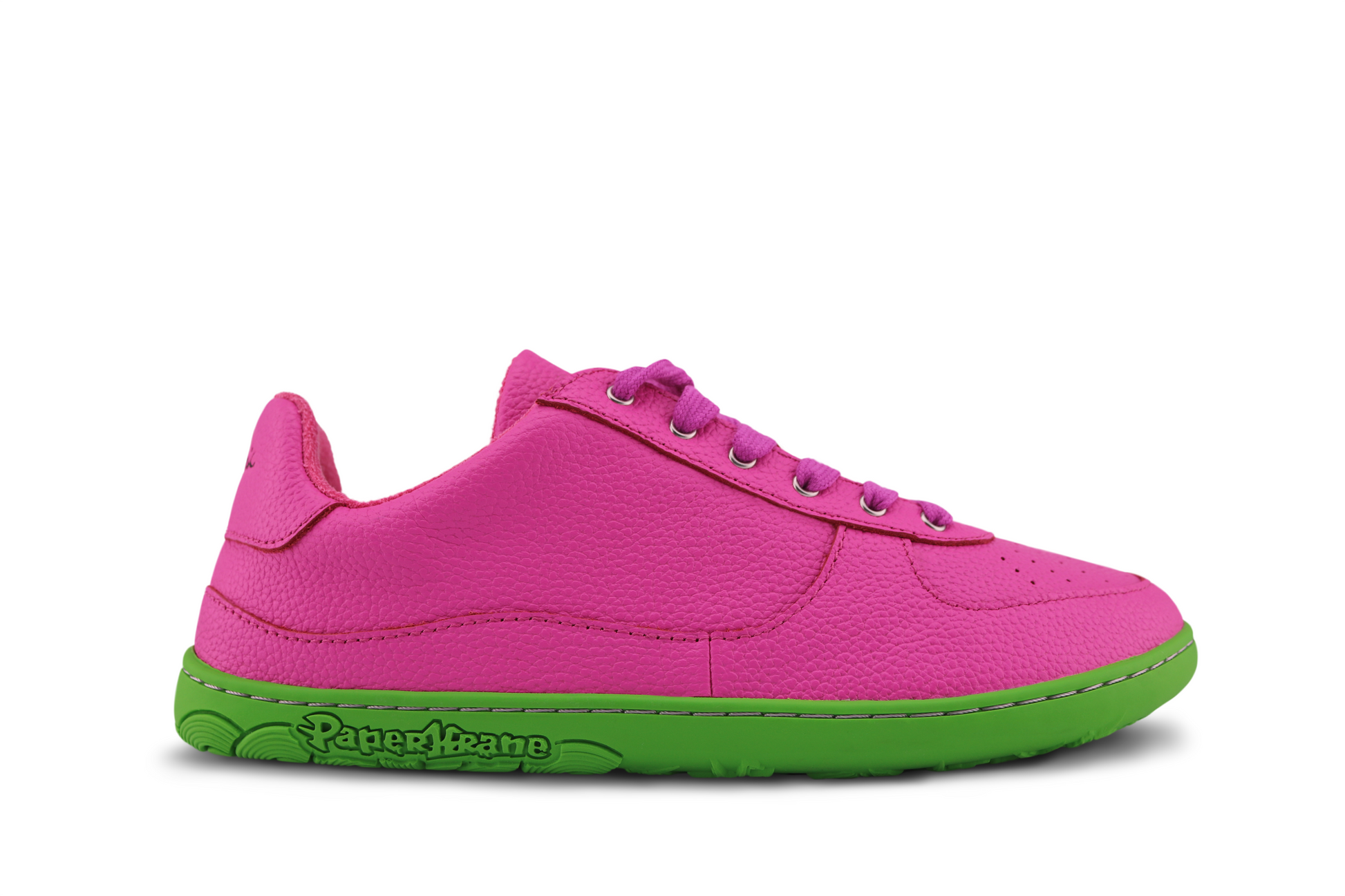 SIDE VIEW OF BRIGHT PINK LEATHER SNEAKER ON GREEN SOLE.