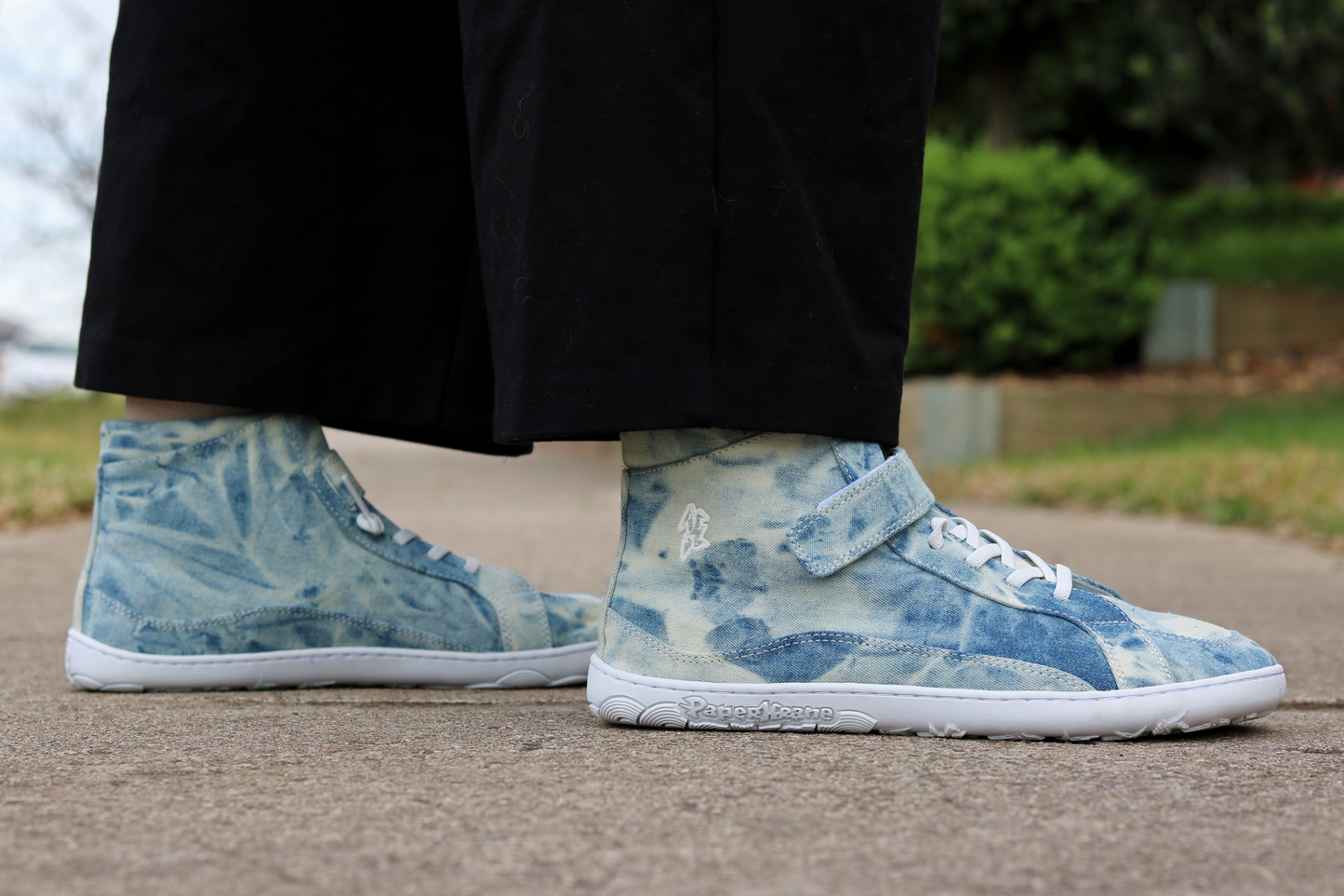 Side view of STONEWASH mid top boots - blue tie dye on cream canvas on adult legs.